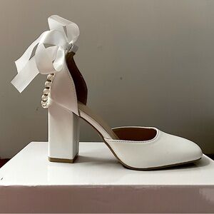 White heels with pearl buckle and white ribbon